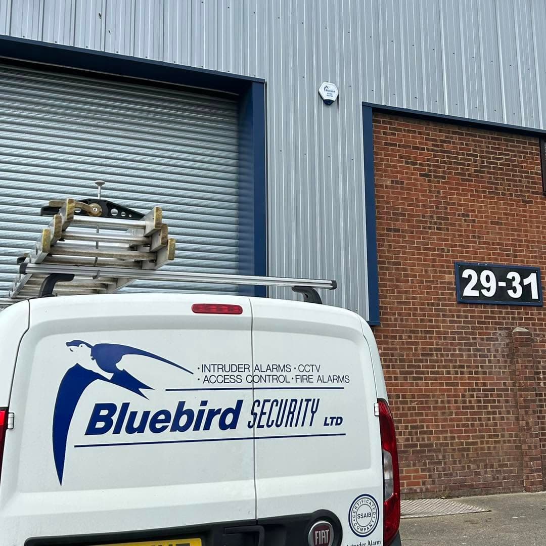 Bluebird Security vehicle outside a commercial premises with an external alarm bell