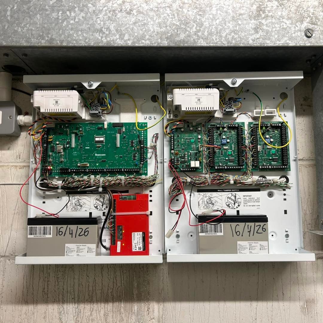 Commercial intruder alarm control panels installed on a wall