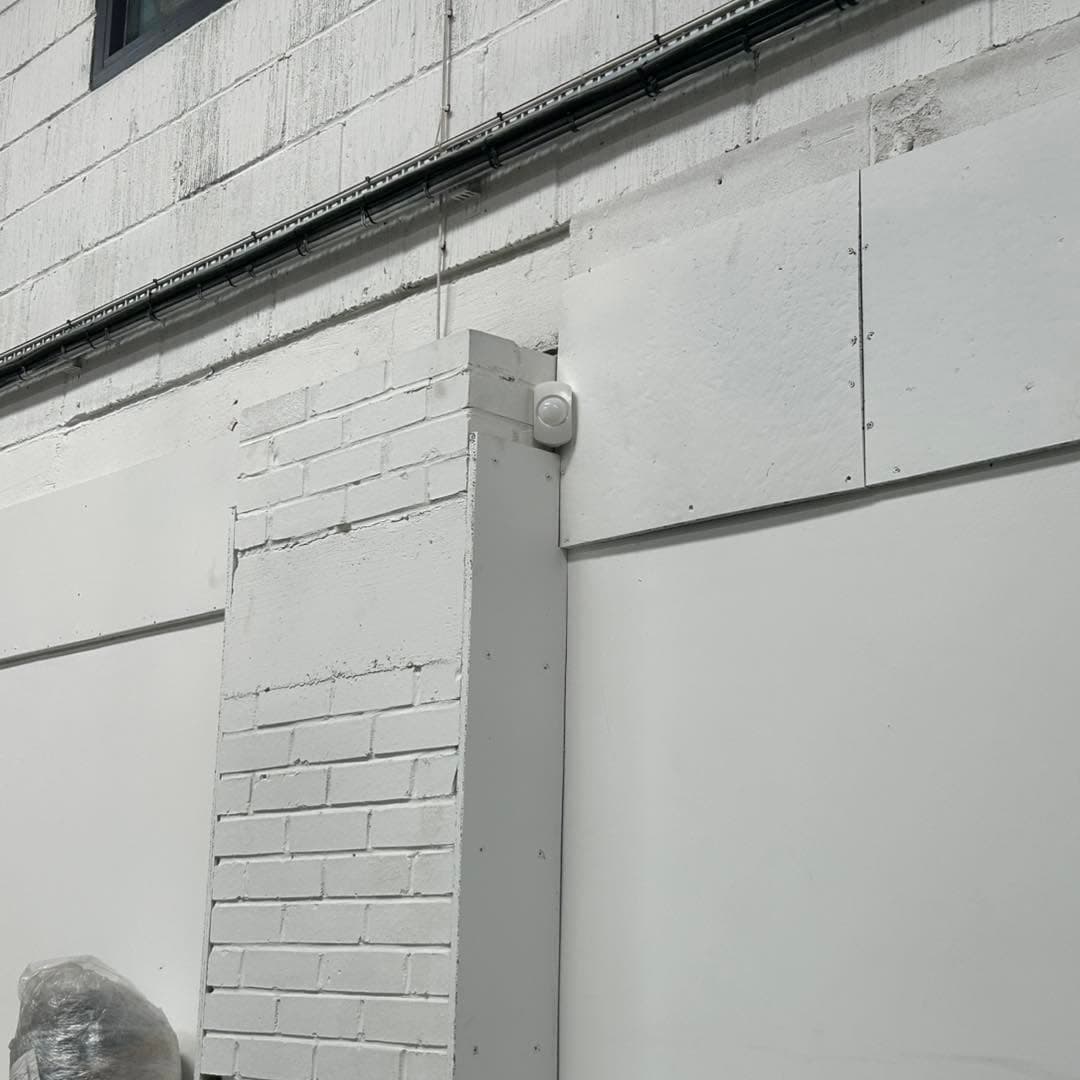 Intruder alarm detector installed on a commercial interior wall