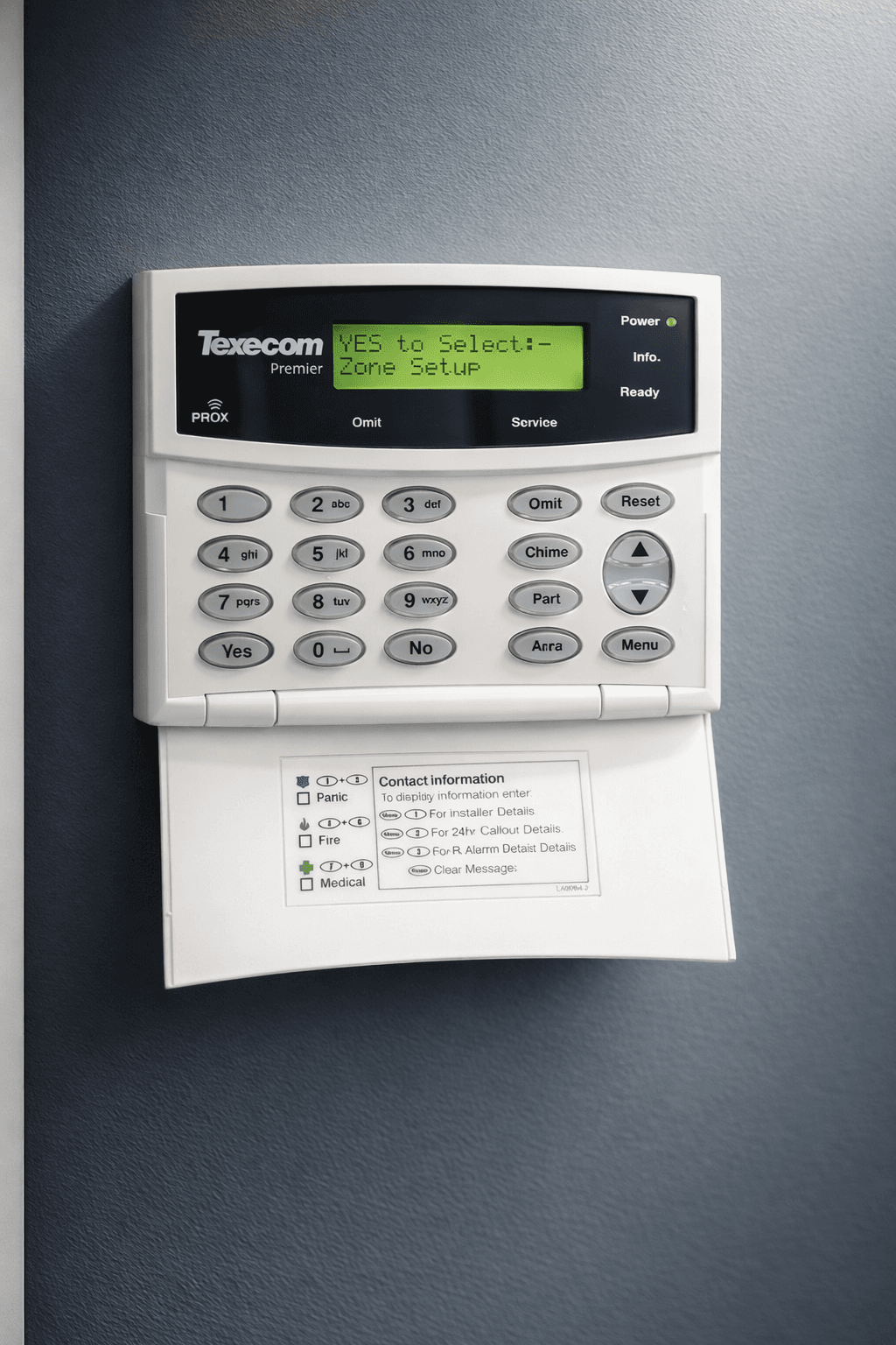 Intruder alarm control keypad mounted on an interior wall