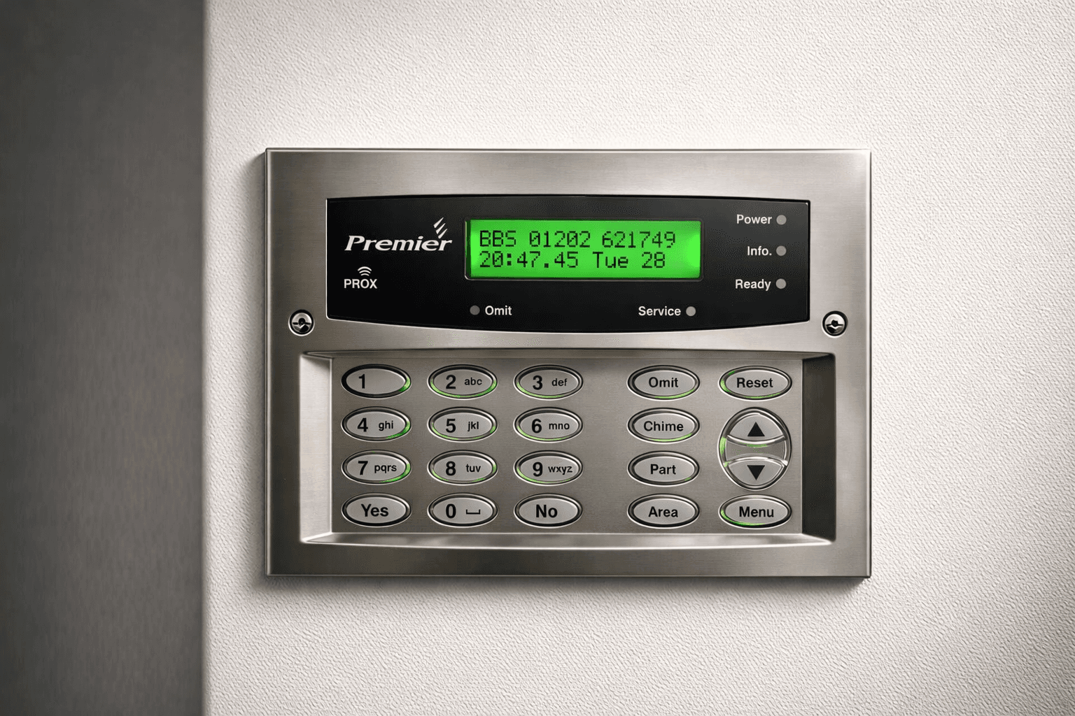 Alarm control keypad mounted on a wall, representing takeover and maintenance support